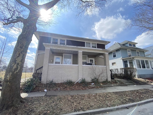 view of front of house with covered porch and brick siding