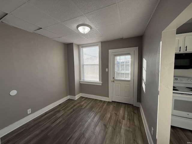 entryway featuring dark wood-type flooring, a paneled ceiling, and baseboards