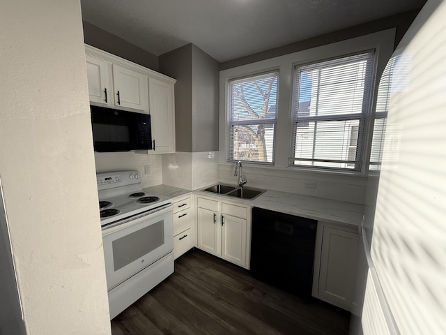 kitchen featuring dark wood-type flooring, white cabinetry, a sink, and black appliances