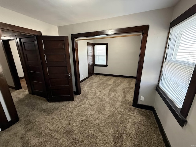 interior space featuring baseboards and carpet flooring