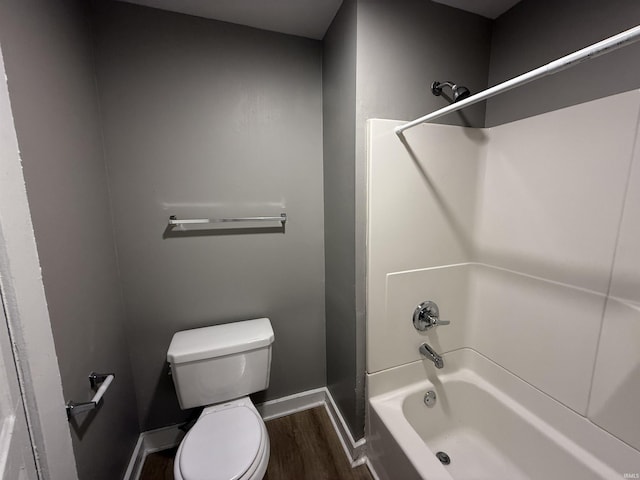 bathroom with  shower combination, baseboards, toilet, and wood finished floors