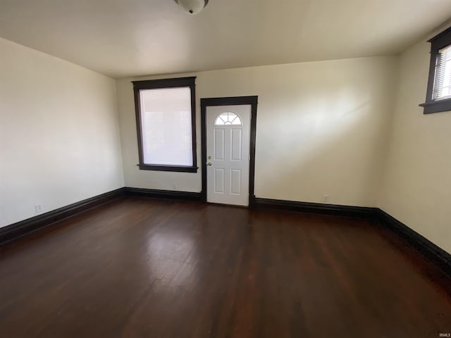 entryway with baseboards and dark wood finished floors