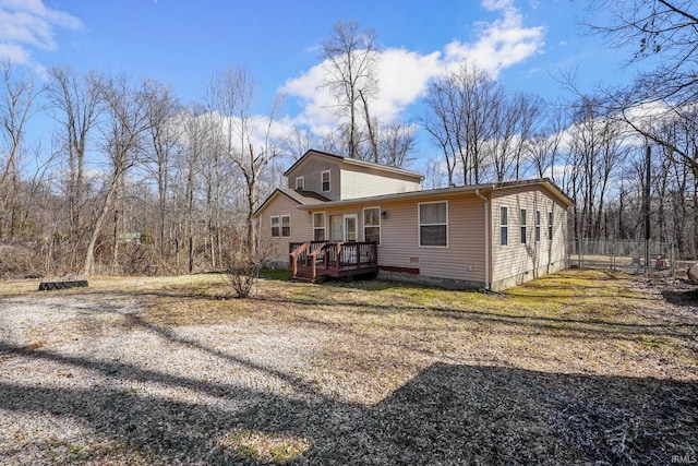 view of front of house with crawl space, fence, and a deck