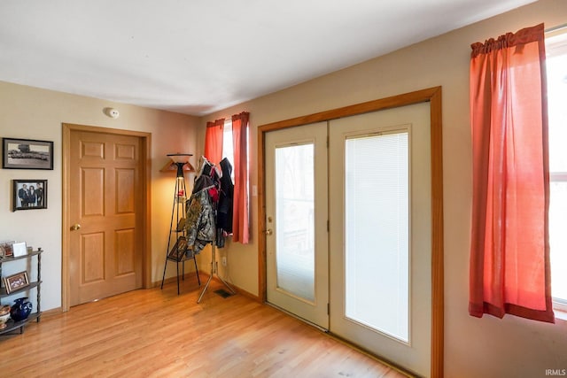 doorway to outside with light wood-type flooring