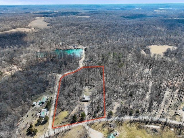 birds eye view of property with a wooded view