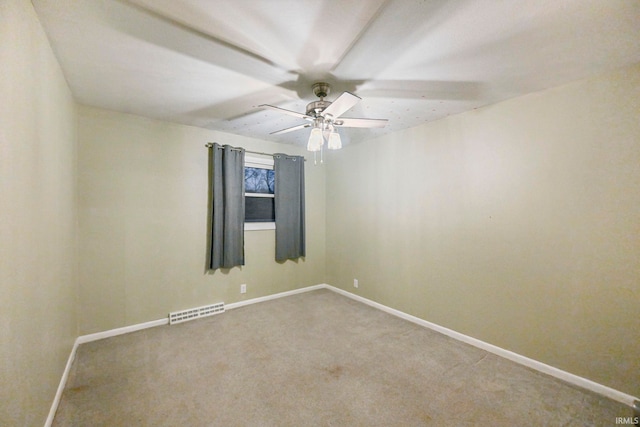 spare room with a ceiling fan, carpet, visible vents, and baseboards