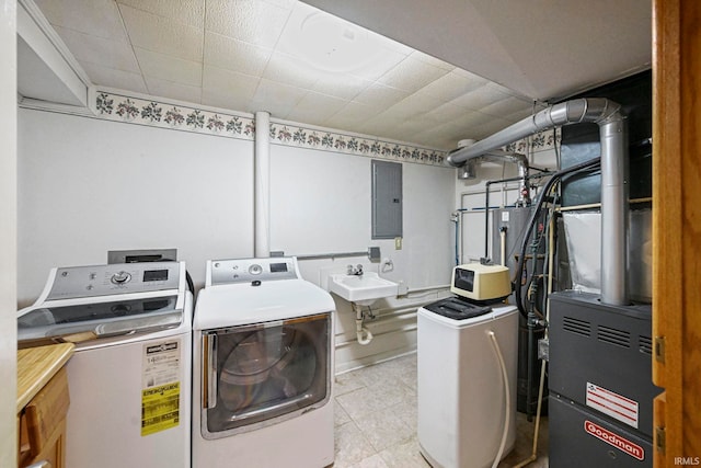 clothes washing area with a sink, laundry area, washing machine and dryer, and electric panel