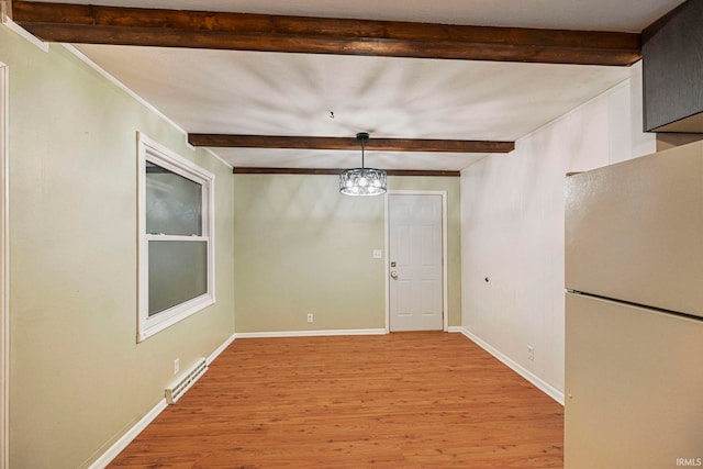 unfurnished dining area with a chandelier, beamed ceiling, light wood-type flooring, and baseboards