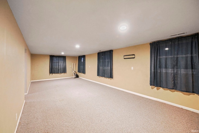 spare room featuring carpet floors, recessed lighting, visible vents, and baseboards