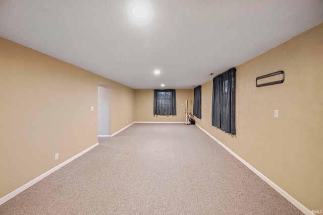 finished below grade area featuring carpet floors, baseboards, and recessed lighting