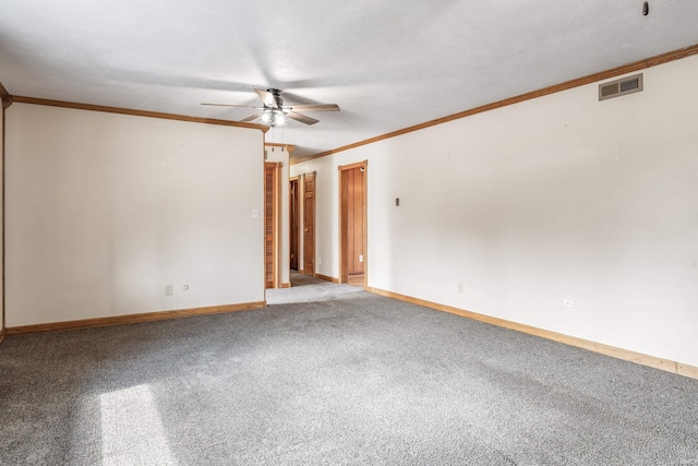 unfurnished room featuring ceiling fan, visible vents, baseboards, ornamental molding, and carpet