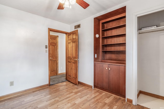 unfurnished bedroom featuring light wood-style flooring, visible vents, and baseboards