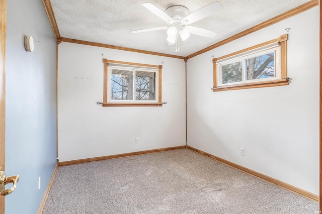 unfurnished room featuring ornamental molding, light colored carpet, a textured ceiling, and baseboards