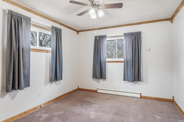 empty room with carpet floors, a baseboard radiator, a textured ceiling, and a wealth of natural light