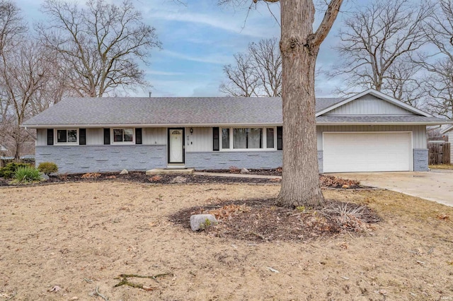 single story home featuring an attached garage and concrete driveway