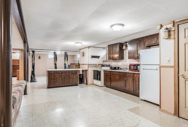 kitchen featuring white appliances, light countertops, dark brown cabinets, and light floors