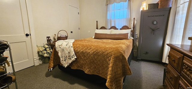 bedroom with dark carpet and a baseboard radiator