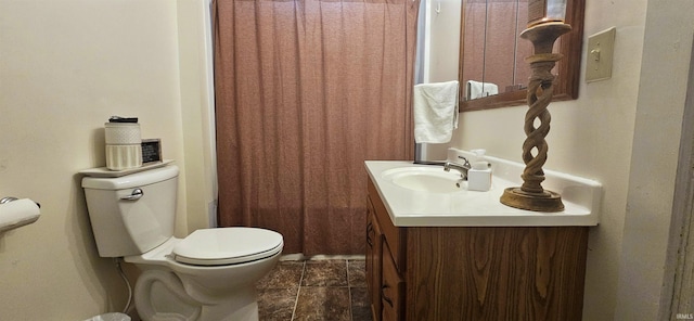 bathroom with toilet, curtained shower, and vanity