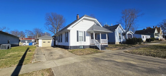 view of front of house featuring a chimney, a front yard, central AC, an outdoor structure, and driveway