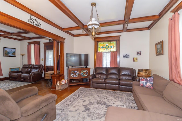 living area with coffered ceiling, beamed ceiling, ornate columns, and wood finished floors