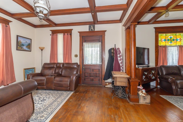 living area featuring coffered ceiling, beamed ceiling, hardwood / wood-style floors, and ornate columns