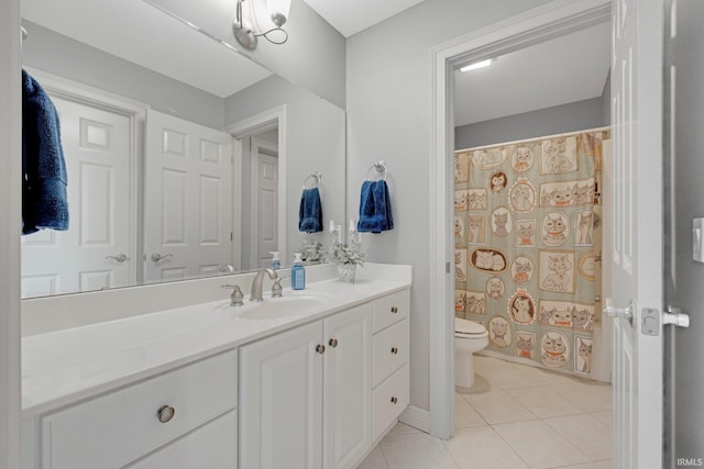 bathroom with vanity, toilet, and tile patterned floors