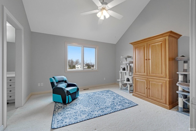 sitting room featuring a ceiling fan, lofted ceiling, light carpet, and baseboards