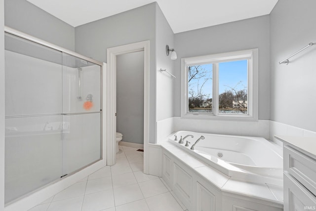 bathroom with a stall shower, tile patterned floors, toilet, and a tub with jets