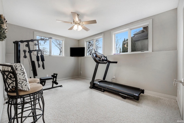 workout area with baseboards and a ceiling fan