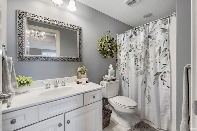 bathroom featuring toilet, visible vents, and vanity