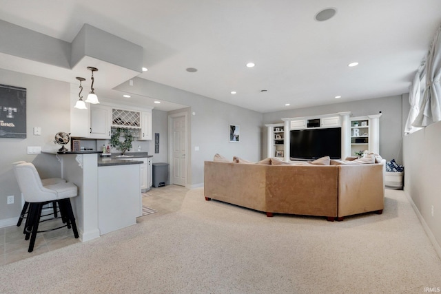 living area with light colored carpet, recessed lighting, baseboards, and wet bar