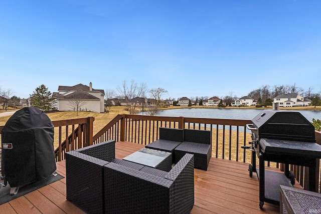 deck with a residential view, a water view, and a grill