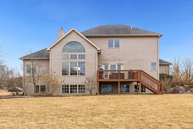 back of house with a wooden deck, stairs, a chimney, and a yard