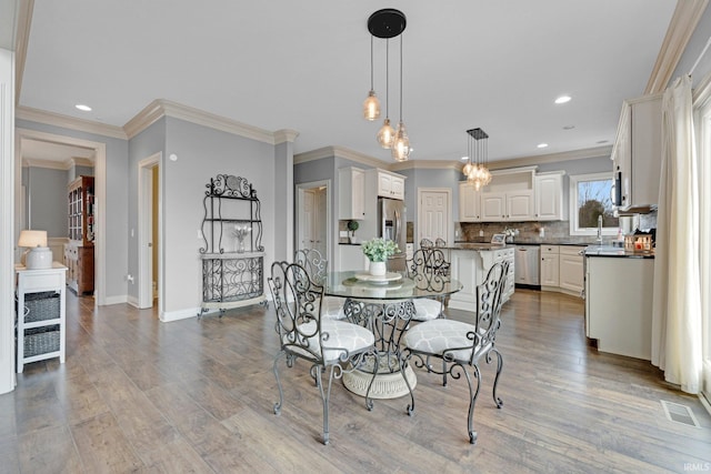 dining room with recessed lighting, visible vents, baseboards, and wood finished floors