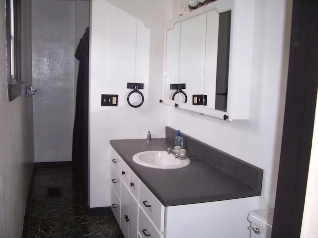 bathroom with marble finish floor, visible vents, vanity, and toilet