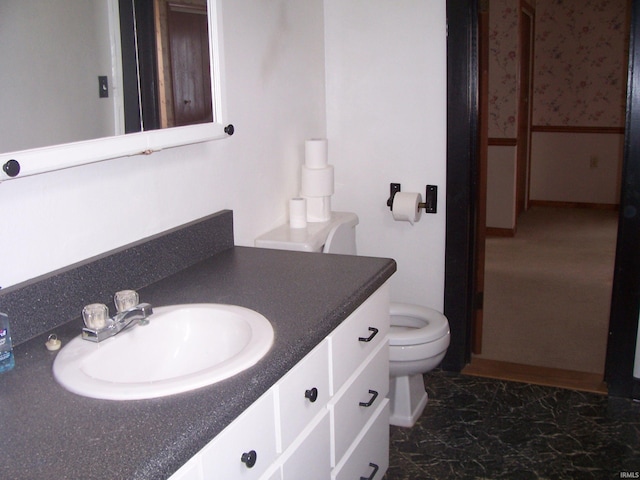 bathroom featuring vanity and toilet