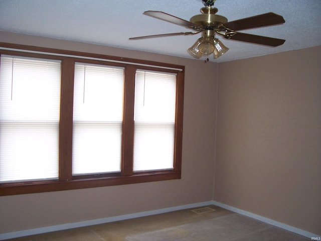 unfurnished room with visible vents and baseboards