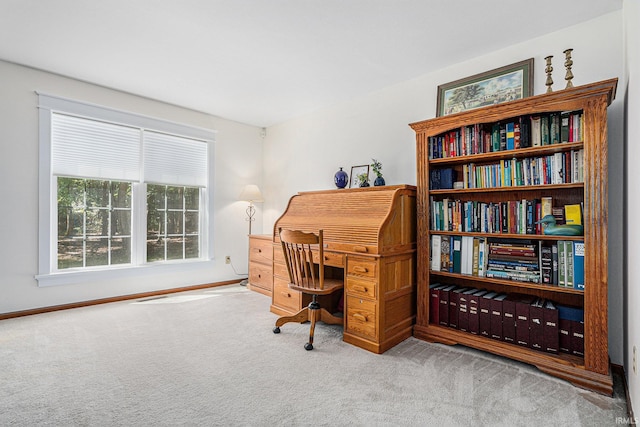 carpeted office space featuring baseboards