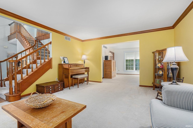 carpeted living area with visible vents, crown molding, and baseboards