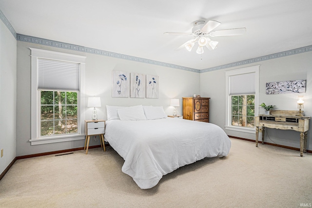 bedroom with carpet flooring, visible vents, baseboards, and multiple windows