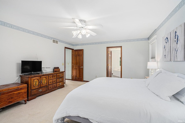 bedroom featuring light carpet, ceiling fan, visible vents, and ensuite bathroom