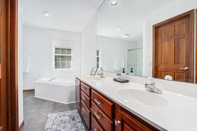 bathroom with double vanity, a garden tub, tile patterned flooring, a shower stall, and a sink