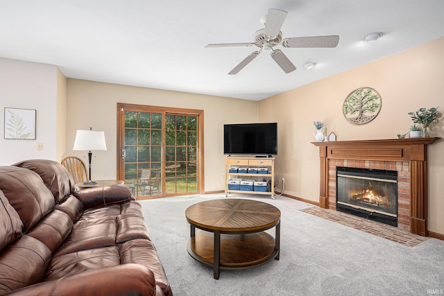 living room with a ceiling fan, carpet, a fireplace, and baseboards