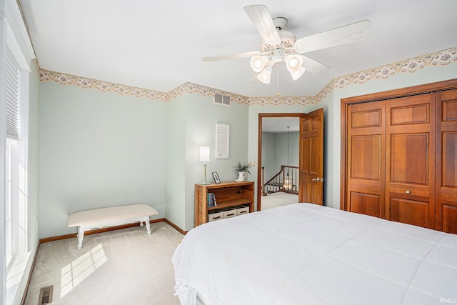 bedroom with light carpet, visible vents, and baseboards