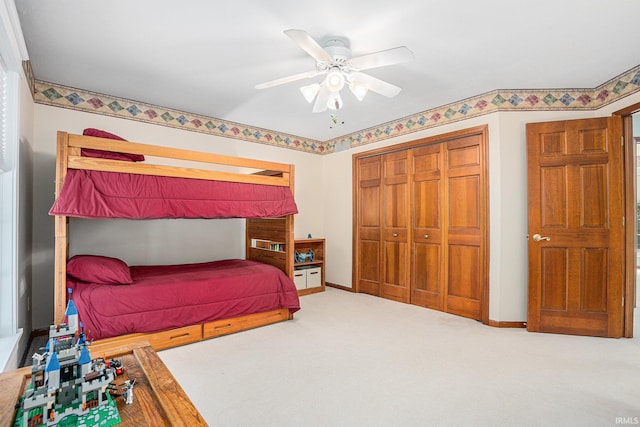 bedroom featuring ceiling fan, a closet, carpet flooring, and baseboards