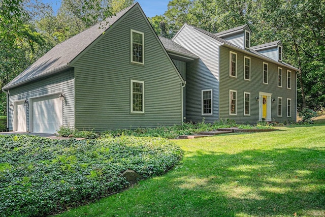 exterior space featuring an attached garage and a front lawn