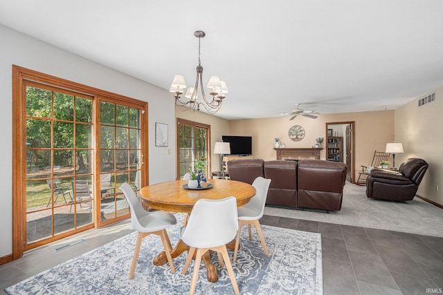 dining room with baseboards, dark tile patterned flooring, visible vents, and a notable chandelier