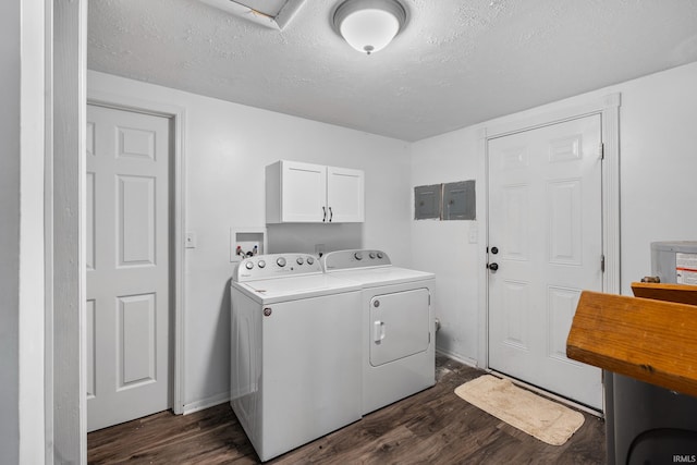 clothes washing area with cabinet space, a textured ceiling, dark wood-type flooring, and independent washer and dryer