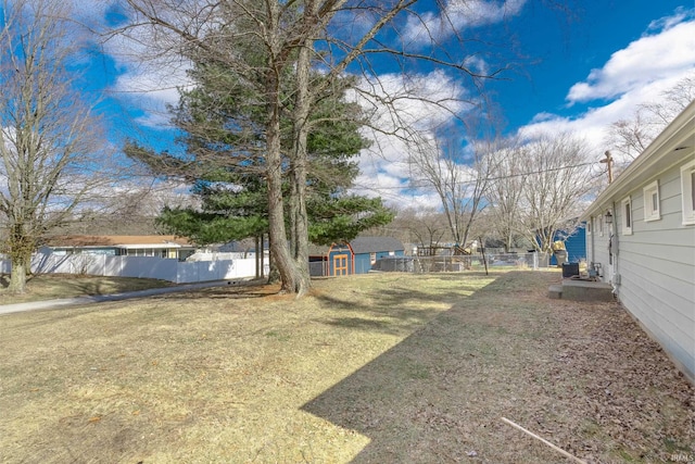 view of yard featuring fence and an outdoor structure