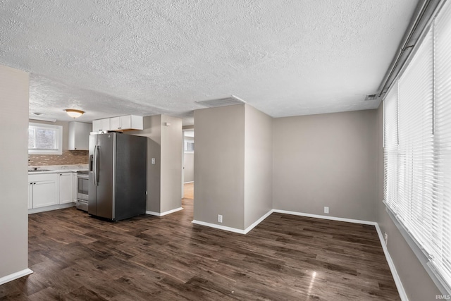 kitchen featuring stainless steel appliances, dark wood-style flooring, white cabinets, and visible vents